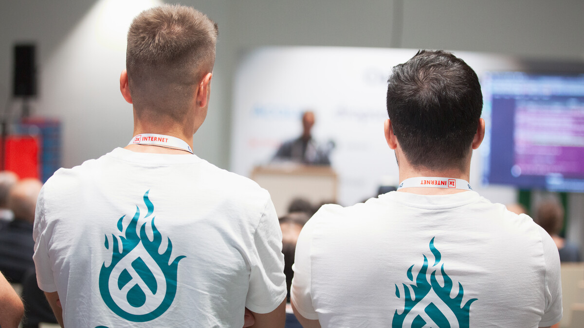 Two drunomics employees watching a presentation at DrupalCon Vienna 2025
