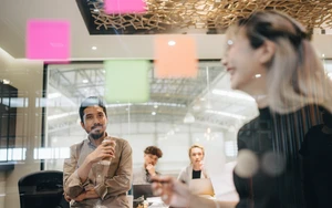 © iStock.com/staticnak1983
Source: iStock.com/staticnak1983 Team Scrum-style meeting using Post-it notes.